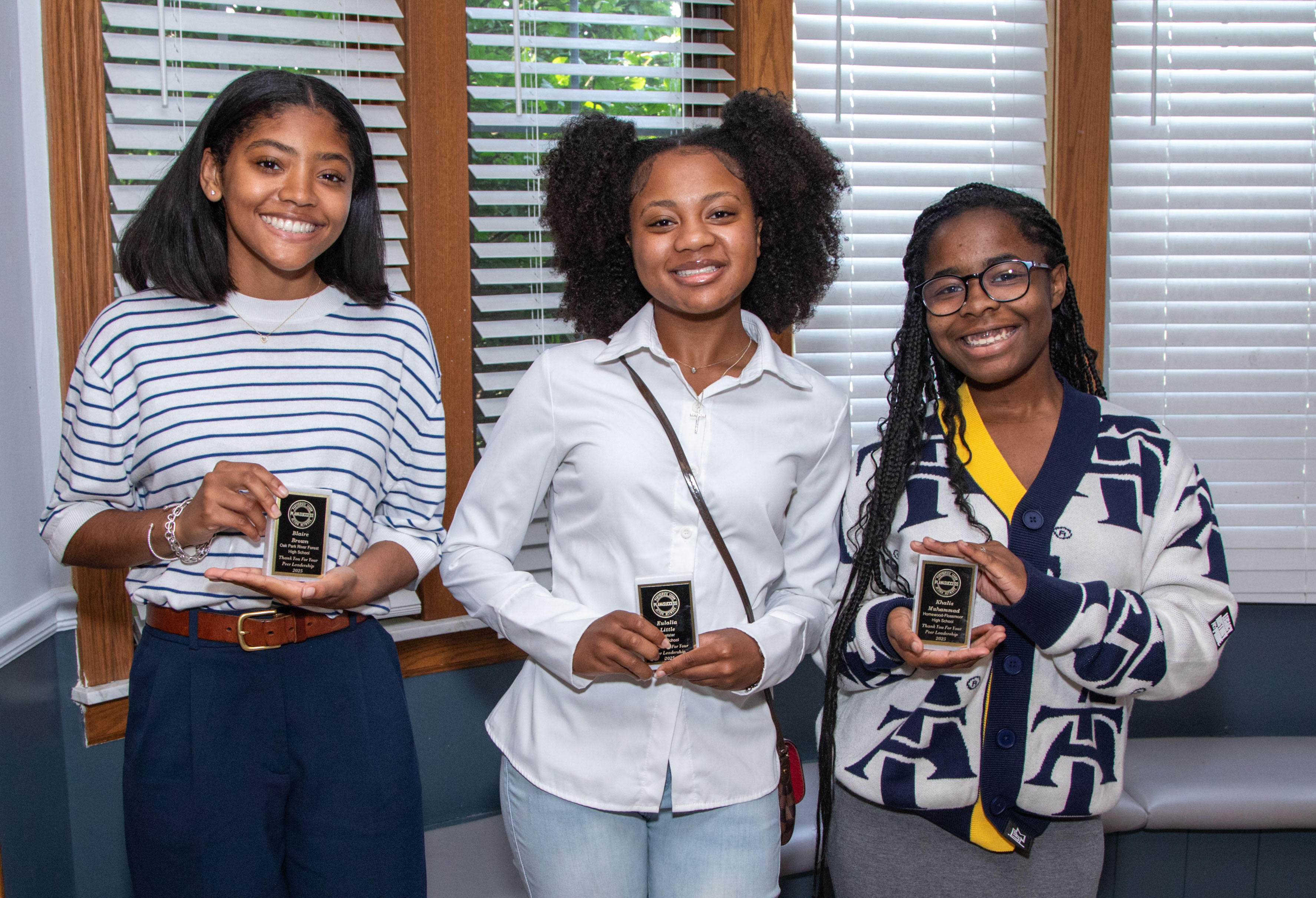 Female Opportunities — three students holding awards